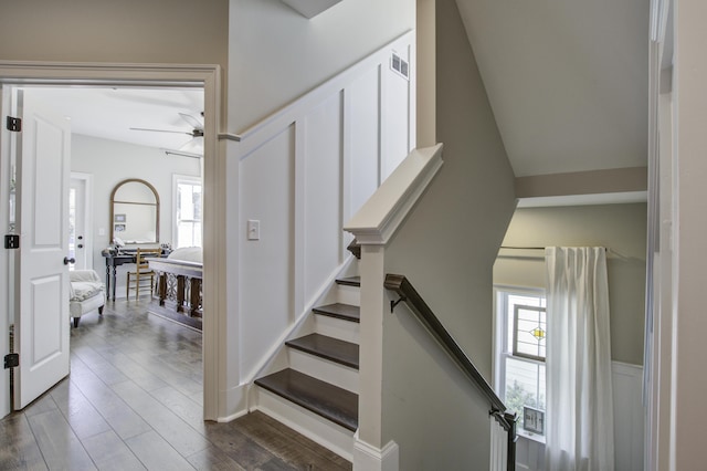 stairs with ceiling fan and hardwood / wood-style floors