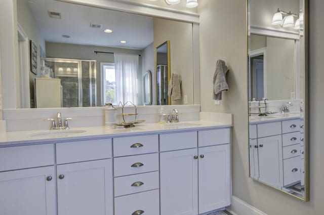 bathroom featuring vanity and a shower with door