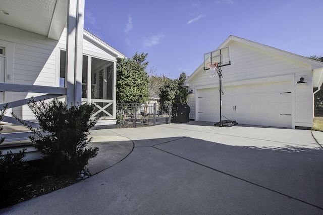 exterior space featuring a garage and a sunroom