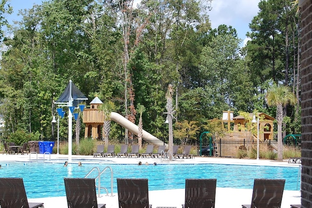 view of swimming pool with a playground