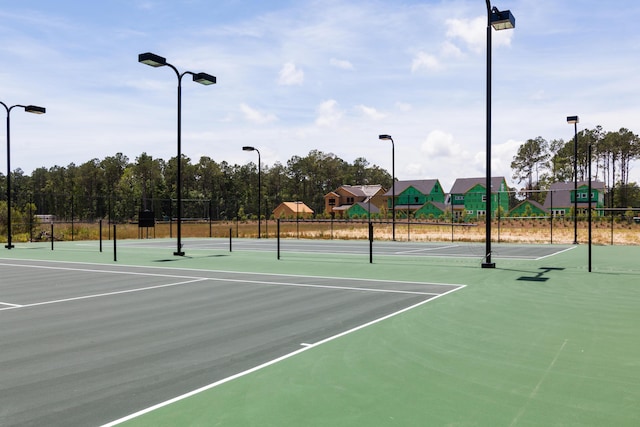 view of tennis court featuring basketball court