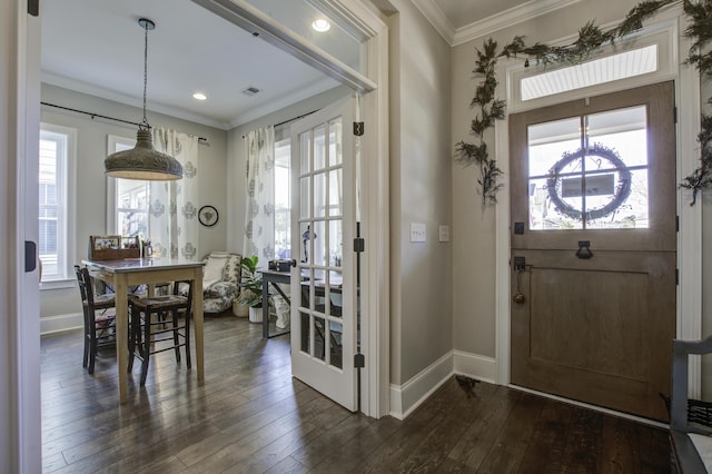 dining room featuring crown molding, a wealth of natural light, and dark hardwood / wood-style flooring