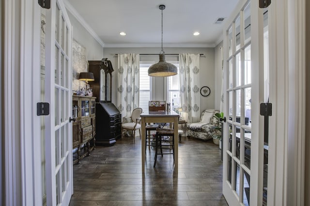 dining room with ornamental molding, dark hardwood / wood-style flooring, and french doors