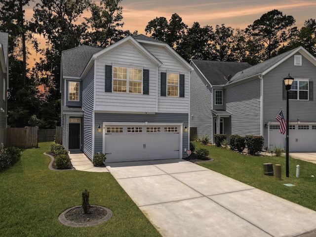 view of front of house with a lawn and a garage