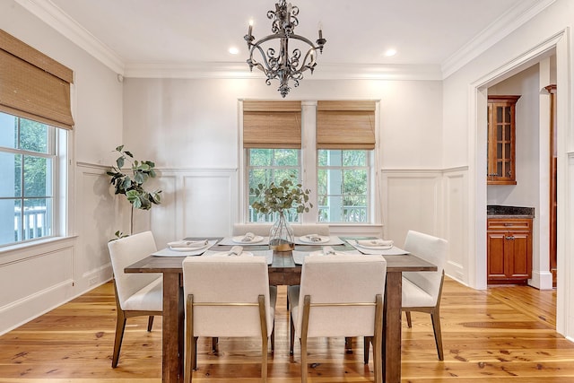 2701 Fountainhead Way, Mount Pleasant, SC 29466 - dining room featuring a decorative wall, light wood-style flooring, a chandelier, a wainscoted wall, and crown molding
