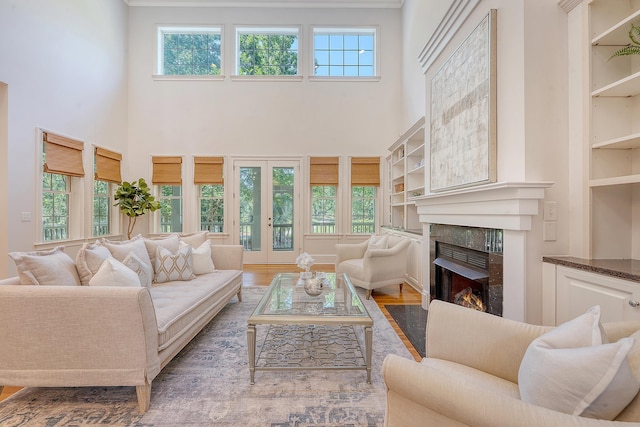 2701 Fountainhead Way, Mount Pleasant, SC 29466 - living room with a high ceiling, a premium fireplace, plenty of natural light, wood finished floors, and built in shelves