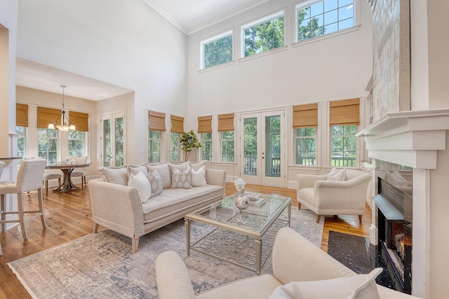 2701 Fountainhead Way, Mount Pleasant, SC 29466 - living room with a chandelier, a towering ceiling, healthy amount of natural light, crown molding, and a tile fireplace