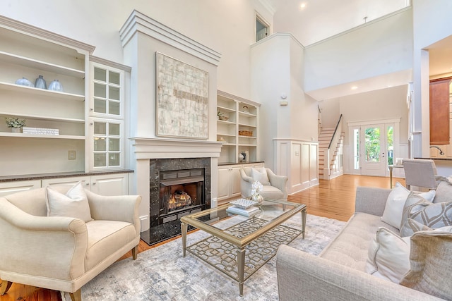 2701 Fountainhead Way, Mount Pleasant, SC 29466 - living area with stairway, light wood-style flooring, a fireplace, and a high ceiling
