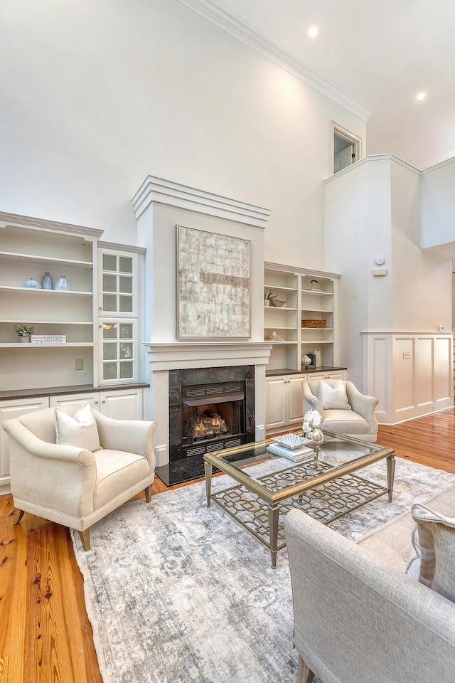 2701 Fountainhead Way, Mount Pleasant, SC 29466 - living area featuring a fireplace, ornamental molding, wood finished floors, a towering ceiling, and recessed lighting