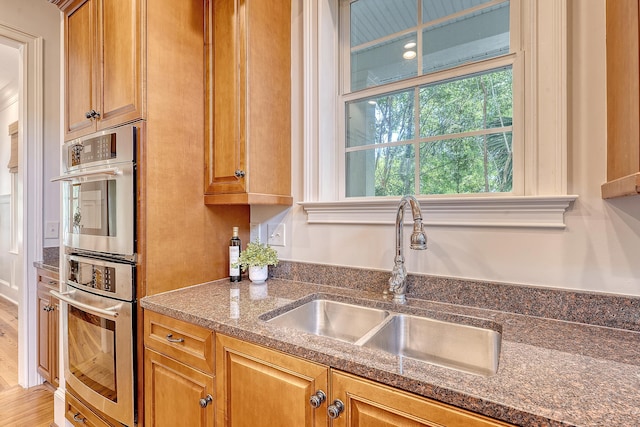 2701 Fountainhead Way, Mount Pleasant, SC 29466 - kitchen featuring a sink, double oven, dark stone counters, and brown cabinets