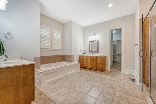 2701 Fountainhead Way, Mount Pleasant, SC 29466 - bathroom featuring a shower stall, two vanities, a garden tub, a walk in closet, and tile patterned flooring