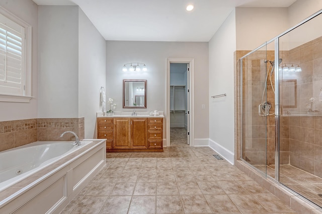 2701 Fountainhead Way, Mount Pleasant, SC 29466 - bathroom featuring vanity, a stall shower, a jetted tub, a spacious closet, and baseboards