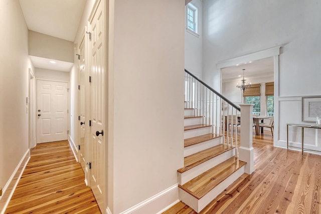 2701 Fountainhead Way, Mount Pleasant, SC 29466 - stairway featuring a chandelier, wood finished floors, a towering ceiling, and baseboards