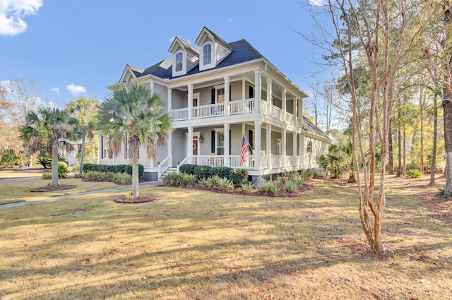 view of front of property with covered porch and a front lawn