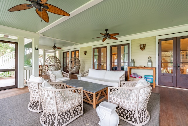 sunroom / solarium featuring ceiling fan and french doors