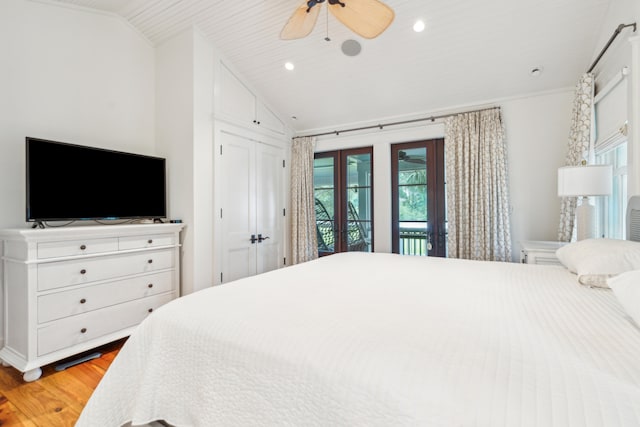 bedroom with lofted ceiling, ceiling fan, french doors, hardwood / wood-style flooring, and access to outside