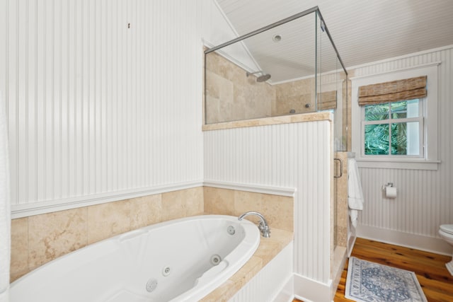 bathroom with shower with separate bathtub, hardwood / wood-style floors, and toilet