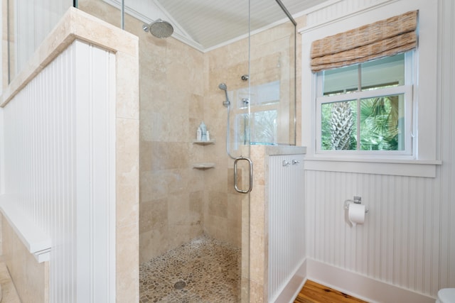 bathroom featuring walk in shower, crown molding, and hardwood / wood-style floors