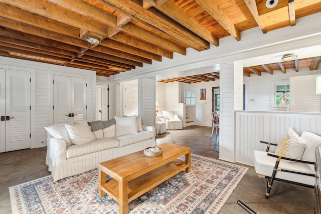 living room with sink, beam ceiling, concrete floors, and a wealth of natural light