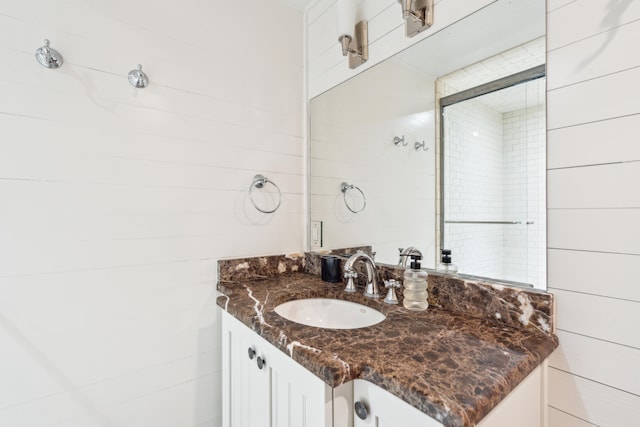 bathroom with vanity and tiled shower