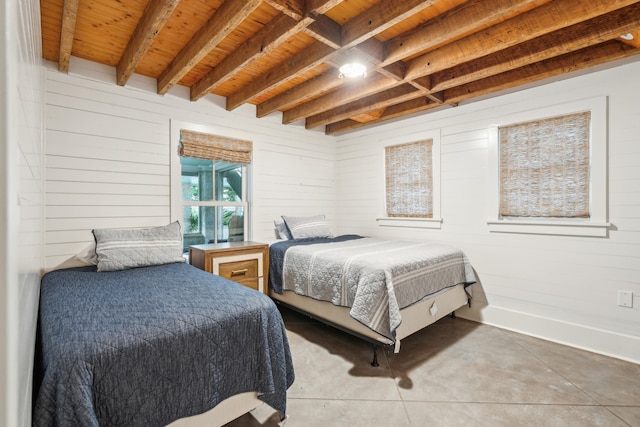 bedroom featuring wooden ceiling, beamed ceiling, and concrete floors