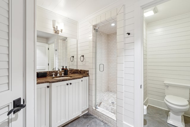 bathroom with vanity, wooden walls, toilet, and an enclosed shower