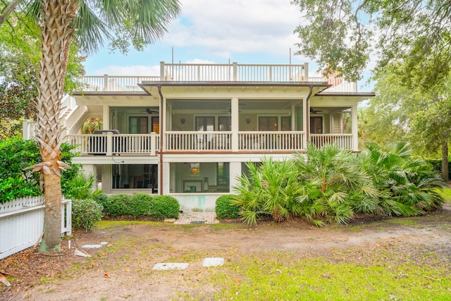 back of property with a balcony, ceiling fan, and a sunroom