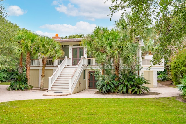 coastal home with a front lawn and french doors