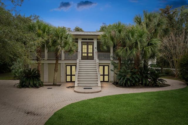 view of front of home featuring french doors and a front lawn