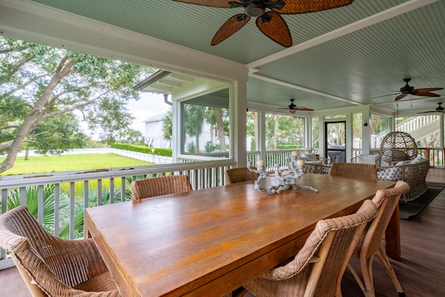 exterior space with ceiling fan and a yard