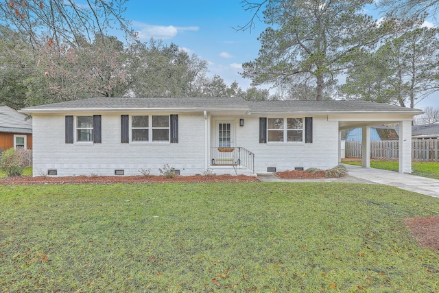 ranch-style house featuring a front yard and a carport