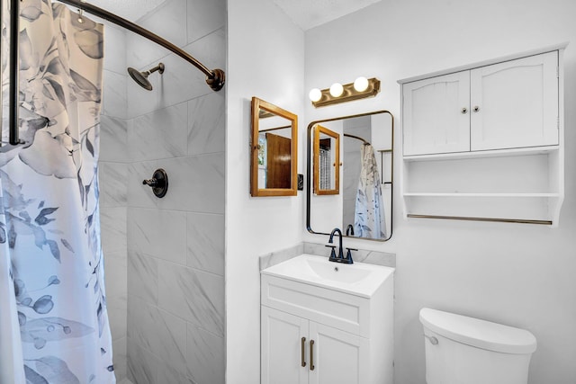 bathroom with toilet, vanity, a textured ceiling, and a shower with shower curtain