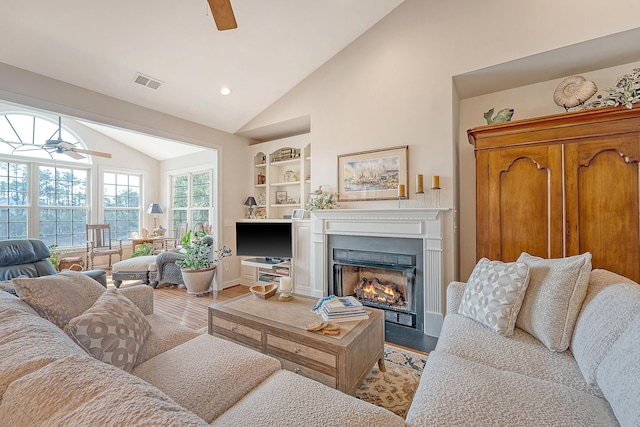 1308 Divot Ct, Mount Pleasant, SC 29466 - living room with ceiling fan, light wood finished floors, high vaulted ceiling, a fireplace with flush hearth, and built in features