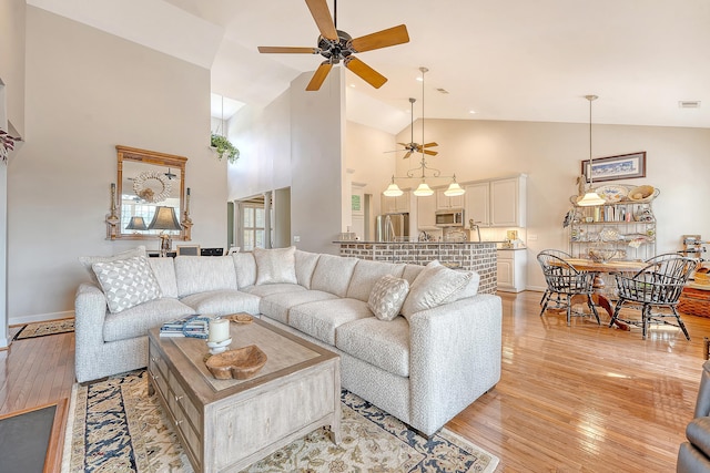 1308 Divot Ct, Mount Pleasant, SC 29466 - living area featuring ceiling fan, light wood-style floors, baseboards, and high vaulted ceiling