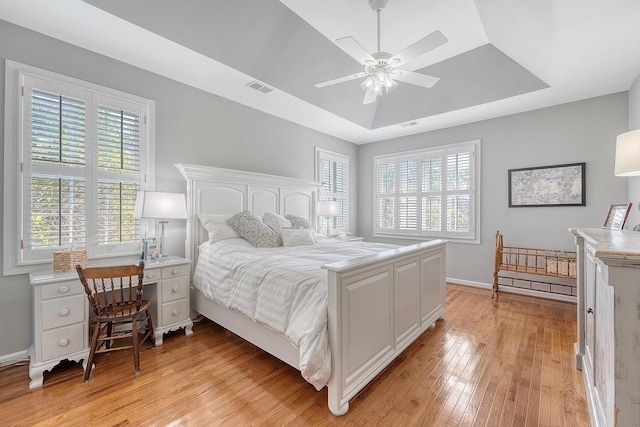 1308 Divot Ct, Mount Pleasant, SC 29466 - bedroom featuring light wood-style flooring, a tray ceiling, baseboards, and ceiling fan