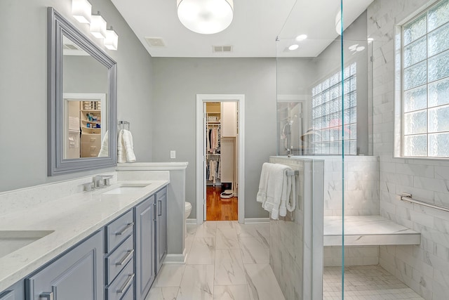 1308 Divot Ct, Mount Pleasant, SC 29466 - bathroom with marble finish flooring, a shower stall, double vanity, toilet, and a walk in closet