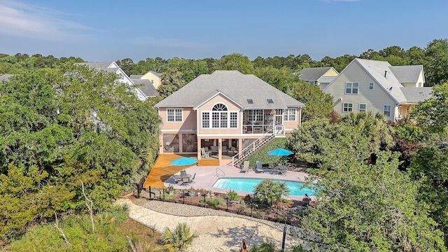 1308 Divot Ct, Mount Pleasant, SC 29466 - back of property featuring a sunroom, stairway, an outdoor pool, a patio area, and a wooden deck