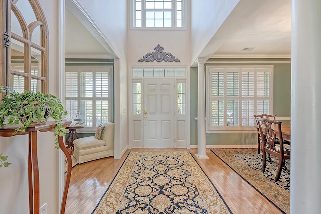 1308 Divot Ct, Mount Pleasant, SC 29466 - entrance foyer featuring ornate columns, wood finished floors, crown molding, baseboards, and a high ceiling