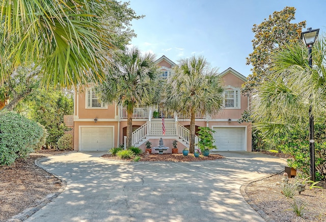 1308 Divot Ct, Mount Pleasant, SC 29466 - view of front of house featuring stairway, an attached garage, stucco siding, and concrete driveway