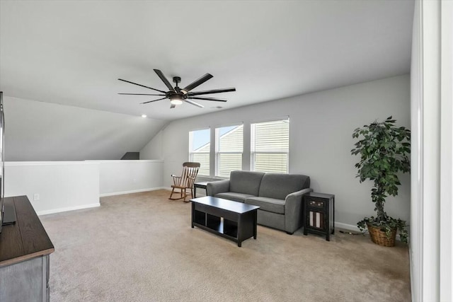 carpeted living room featuring vaulted ceiling and ceiling fan