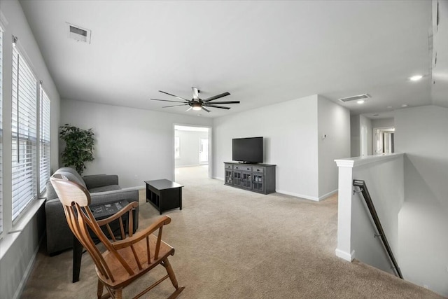 carpeted living room with ceiling fan