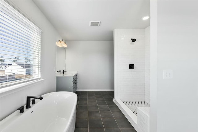 bathroom with tile patterned flooring, vanity, and separate shower and tub