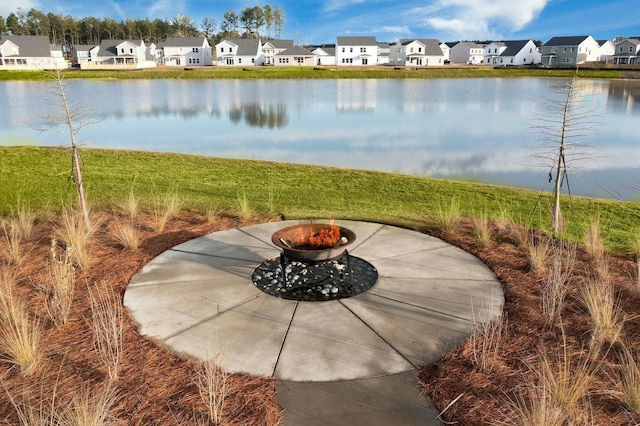 property view of water with an outdoor fire pit