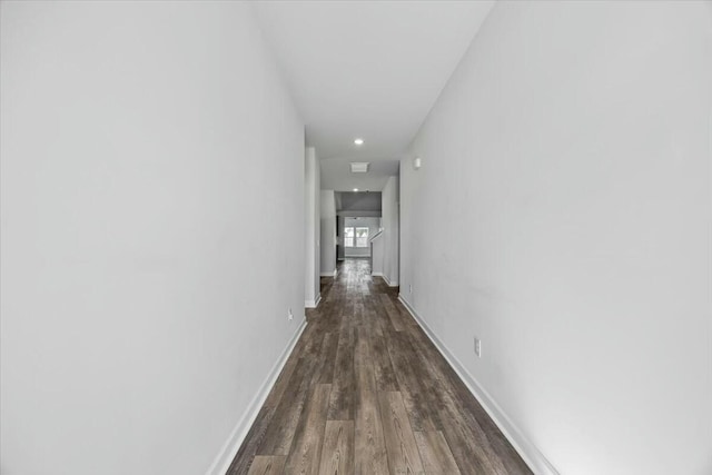 hallway with dark hardwood / wood-style flooring