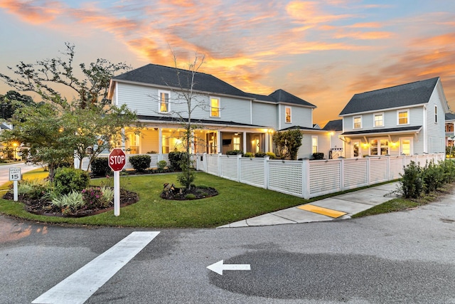 view of front of property featuring a yard and covered porch