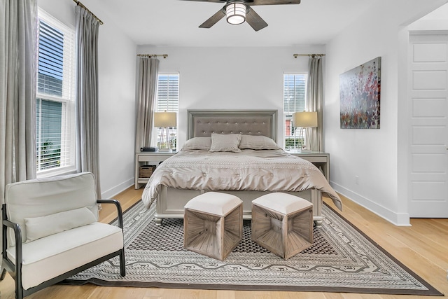 bedroom with wood-type flooring and ceiling fan