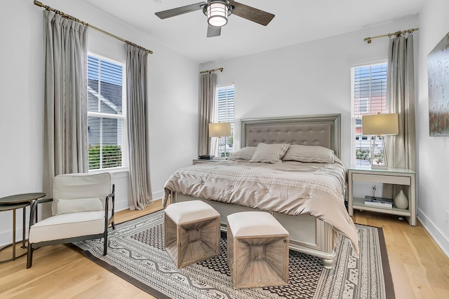 bedroom with light hardwood / wood-style floors and ceiling fan