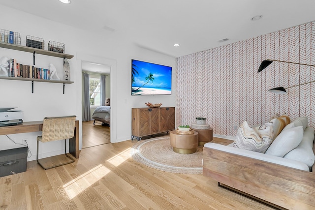 living area with built in desk and light hardwood / wood-style floors