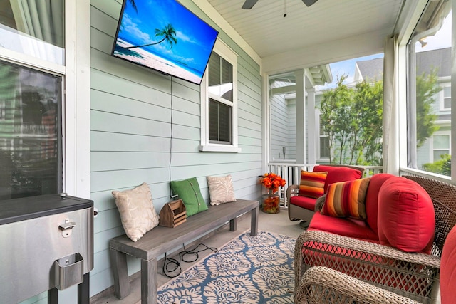 sunroom featuring ceiling fan