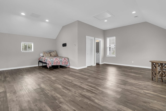 bedroom with multiple windows, vaulted ceiling, and dark hardwood / wood-style floors